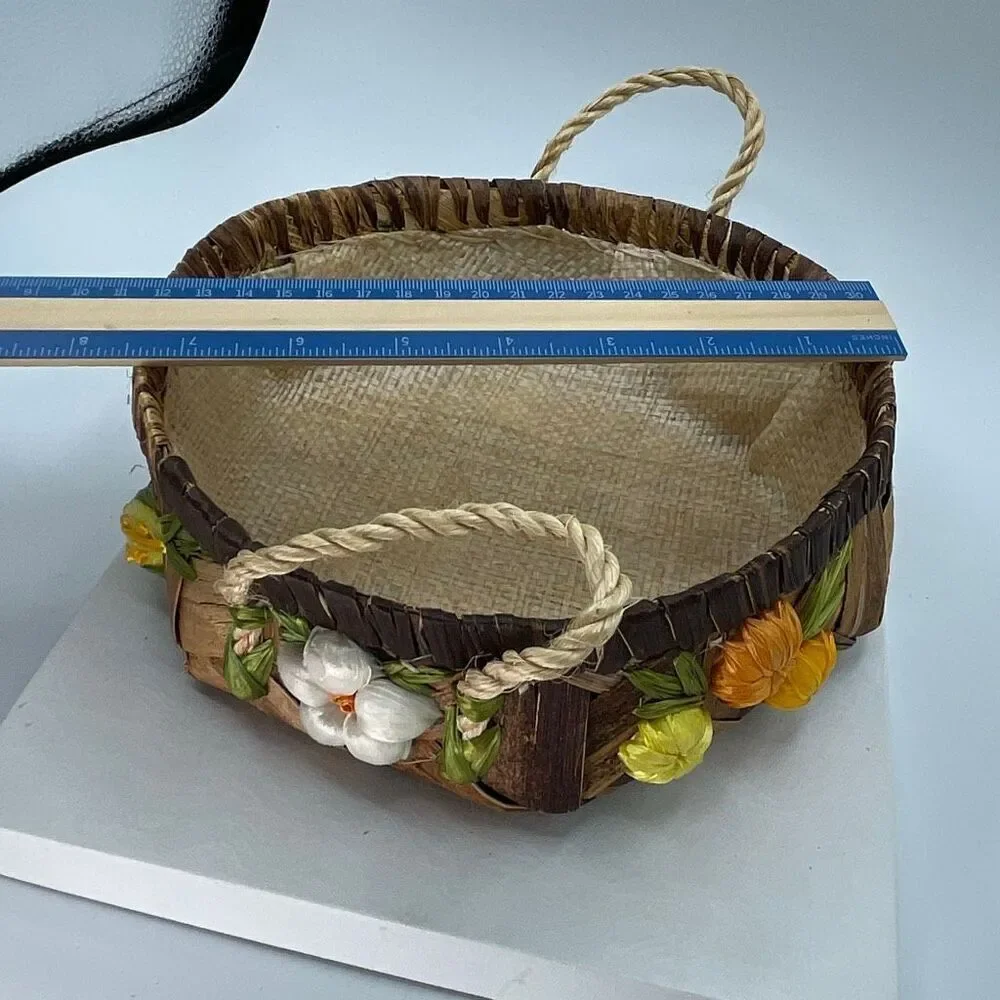 Vintage woven raffia basket with flowers and handles. Lined.